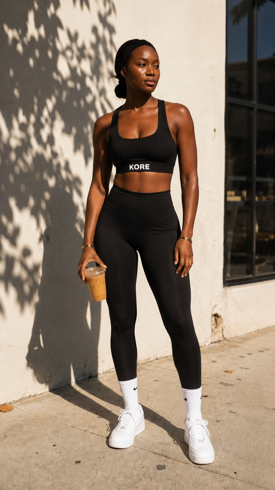 KORE woman in luxury activewear on a sunlit coffee run — confidence and presence